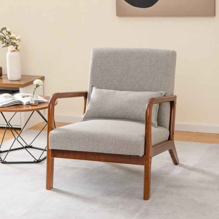 Modern accent chair with rubber wood frame, gray faux linen fabric, and lumbar pillow, perfect for relaxation.