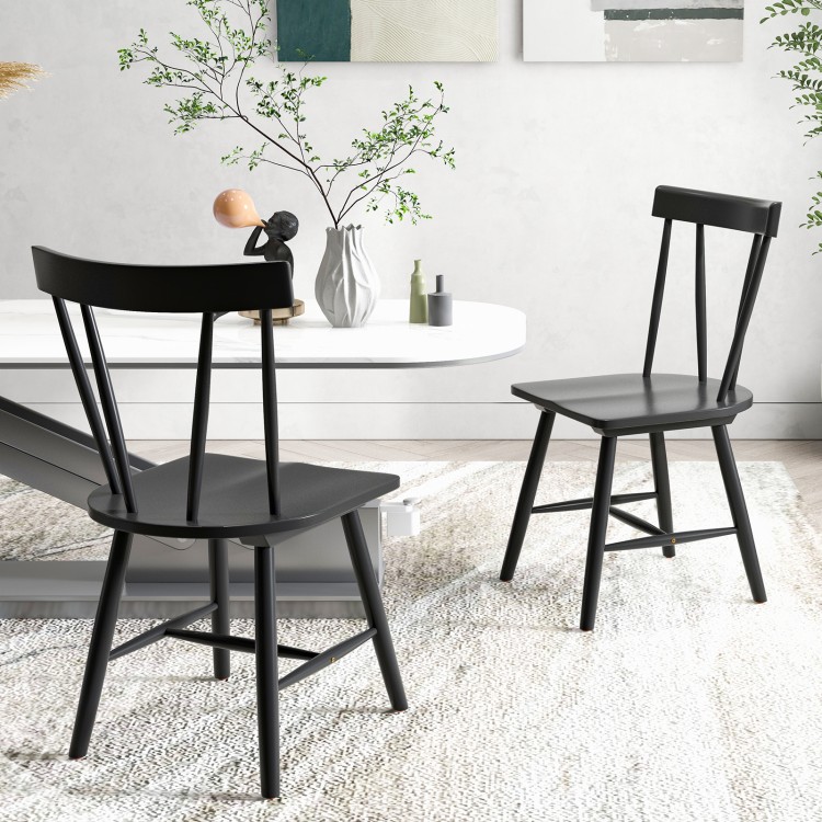 Two Windsor style armless chairs in black with solid rubber wood frames, perfect for dining or living room use.