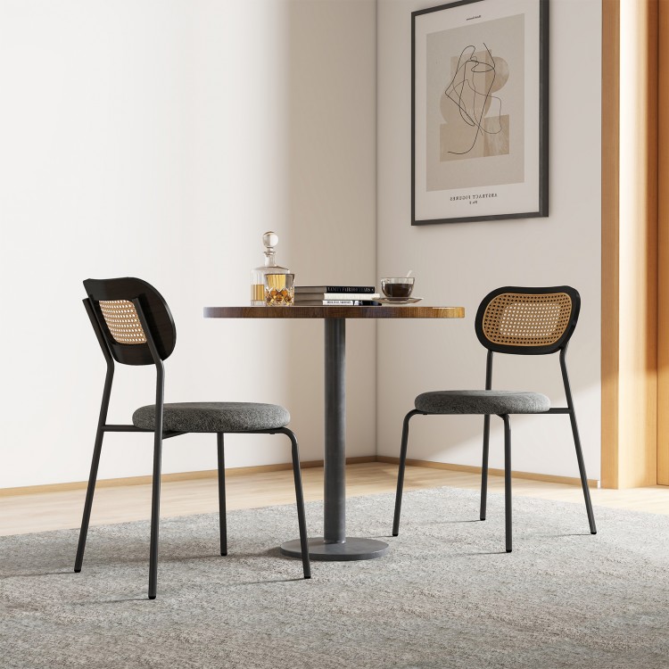 Gray rattan dining chair featuring a curved backrest and soft cushion, designed for comfort and modern aesthetics.
