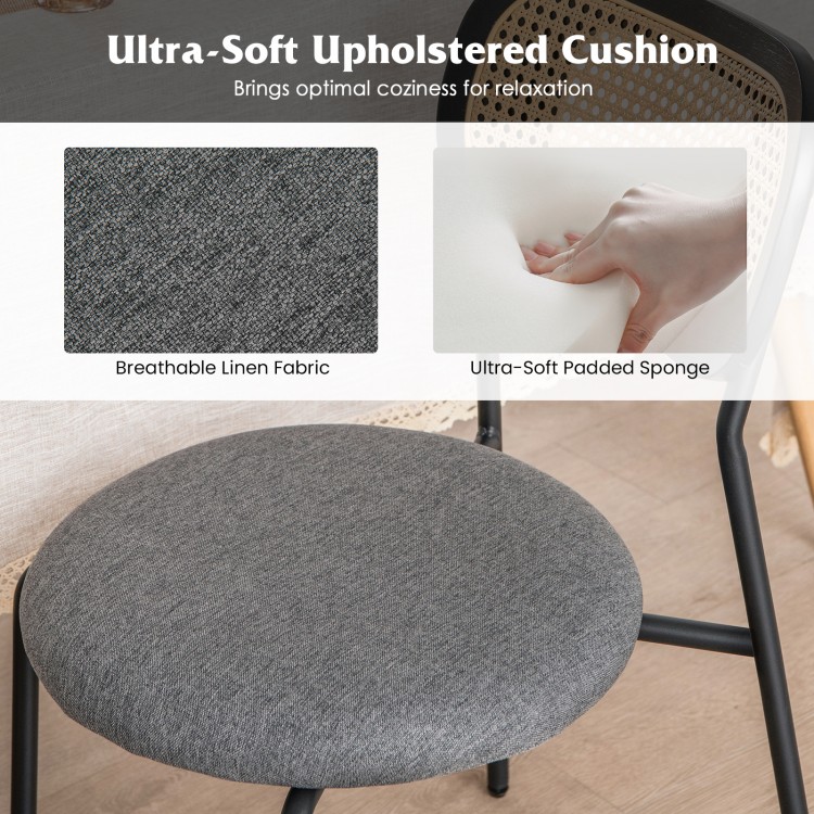 Gray upholstered cushion of a rattan dining chair, featuring breathable linen fabric and ultra-soft padding for comfort.