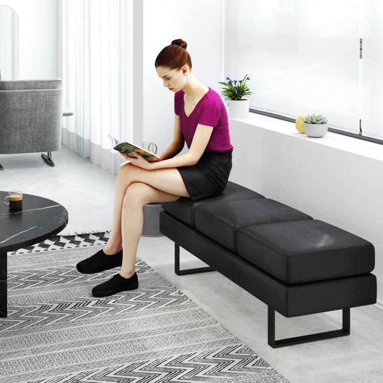 Long black waiting room bench with metal frame, featuring removable cushions, ideal for reception areas.