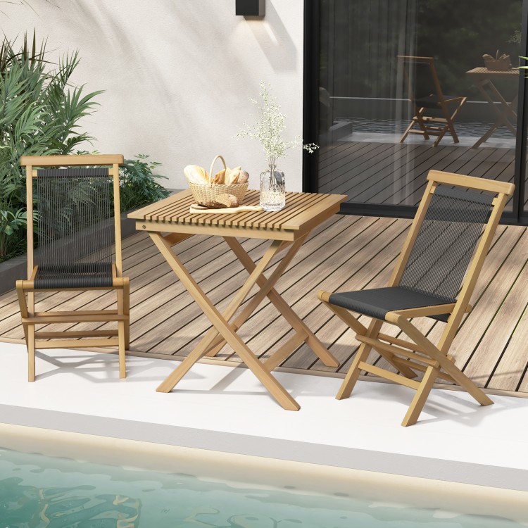 Two Indonesia teak patio folding chairs with woven rope seats beside a folding table, perfect for poolside relaxation.