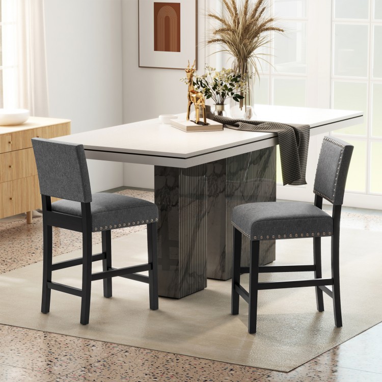 Counter height chairs with solid rubber wood frame, cushioned seats, and stylish rivets, perfect for dining areas.