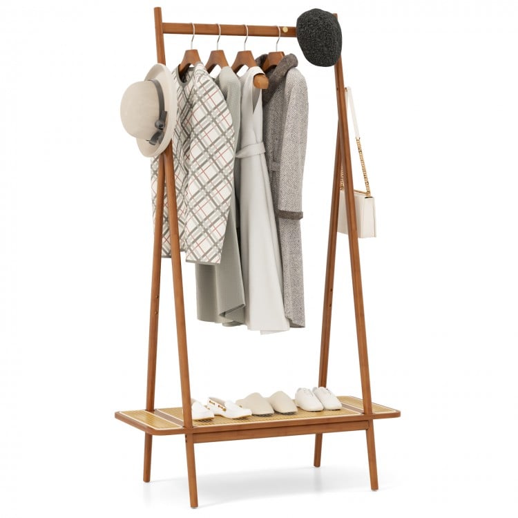 Bamboo clothes rack with hanging rod, rattan shelf, and copper hooks for organized entryway storage.
