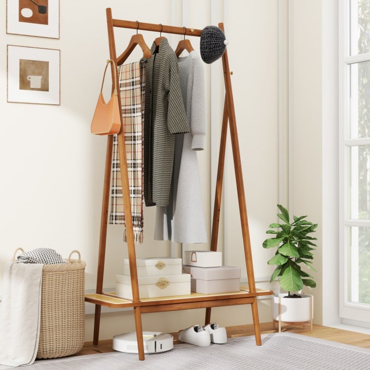 Bamboo clothes rack showcasing a rattan shelf and multiple hooks, providing stylish storage for hats and bags in any.