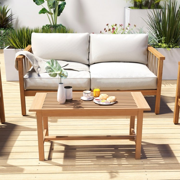 Rectangular 36-inch patio coffee table made of teak wood with slatted tabletop, ideal for outdoor use by the poolside.