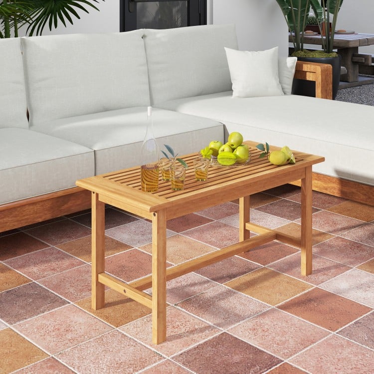 Rectangular 36-inch patio coffee table made of teak wood with a slatted tabletop, ideal for outdoor use and gatherings.