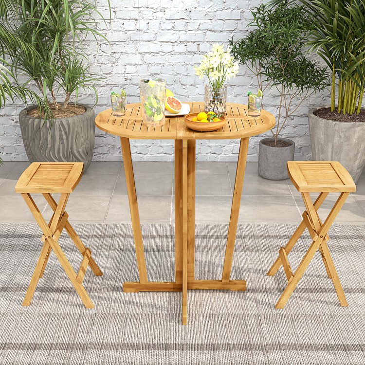 Outdoor folding bar table with oval teak wood tabletop and cross base, perfect for small dining areas.