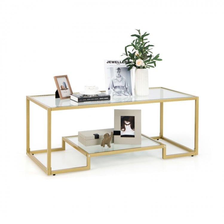 Modern 2-tier rectangular coffee table with a golden frame and glass top, ideal for living room or office decor.