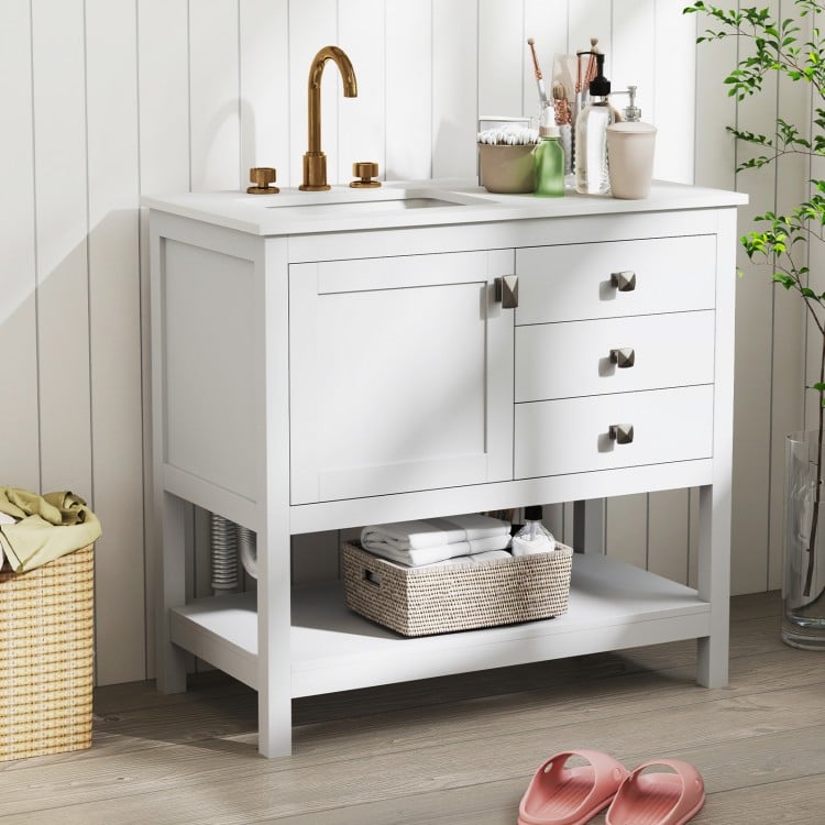 Freestanding bathroom vanity unit in white with ceramic sink, granite countertop, and ample storage for grooming.