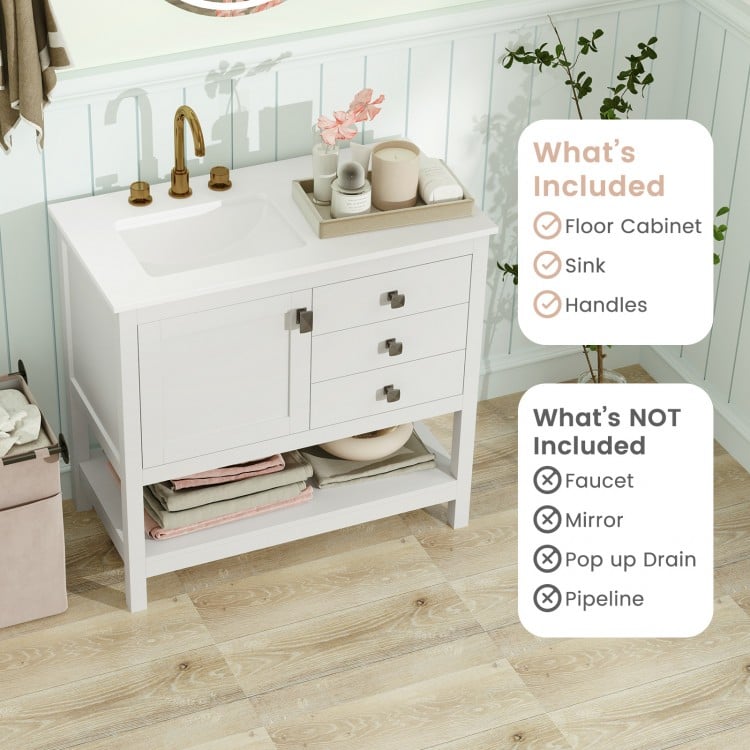 Freestanding bathroom vanity unit in white with ceramic sink, granite countertop, and storage drawers for grooming.