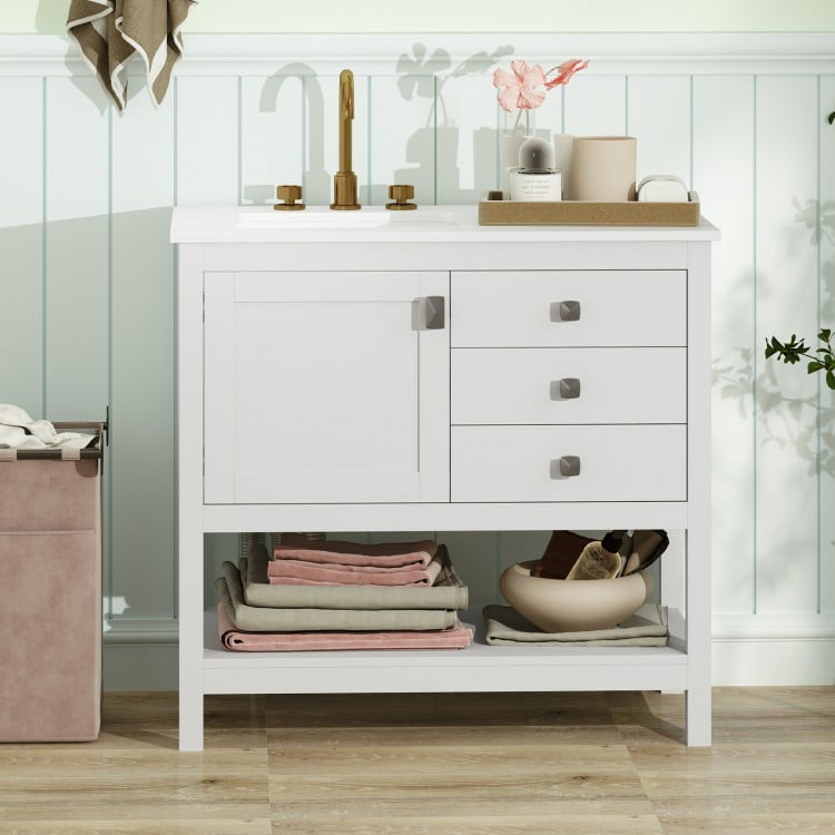 Freestanding bathroom vanity unit in white featuring a spacious countertop, cabinet, and open shelf for organized.