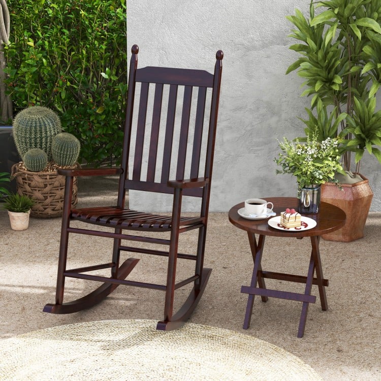 High-back acacia wood outdoor rocking chair in brown with a solid rocking base, perfect for backyard relaxation.