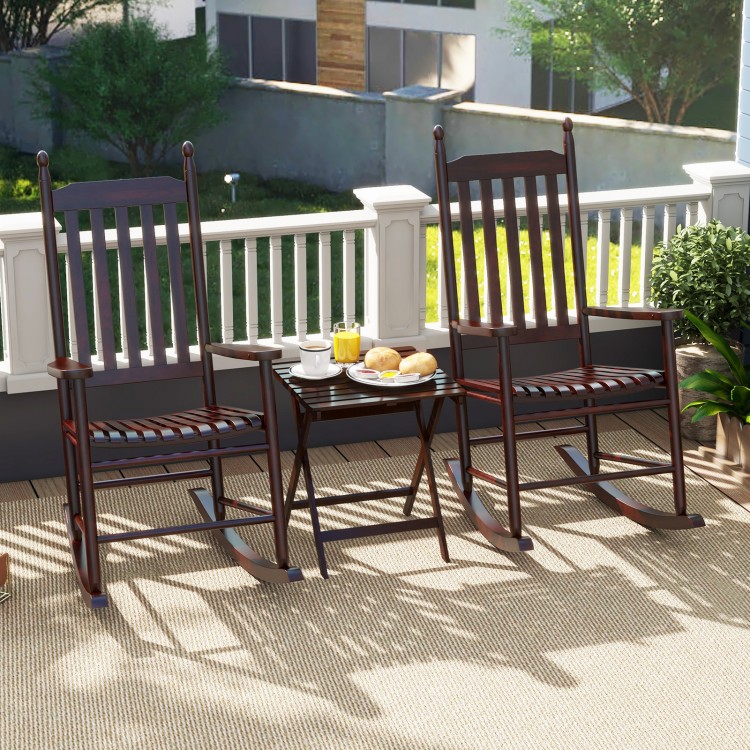 High-back acacia wood outdoor rocking chairs with a solid base, perfect for backyard relaxation on a sunny day.