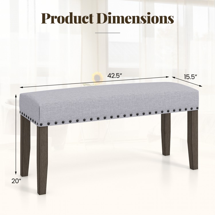 Gray upholstered entryway bench measuring 42.5" x 15.5", featuring nailhead trim and strong rubber wood legs.