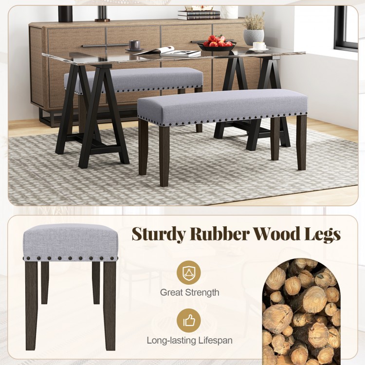 Gray upholstered entryway bench with rubber wood legs, nailhead trim, and spacious seating for versatile use.