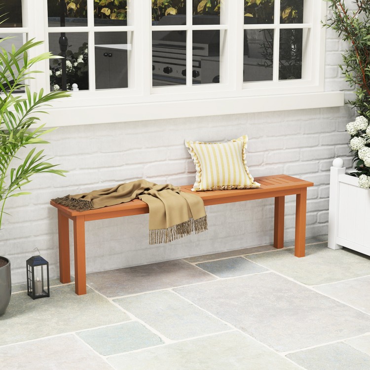 Backless wooden bench with teak oil finish, slatted design for ventilation, ideal for outdoor patios or balconies.