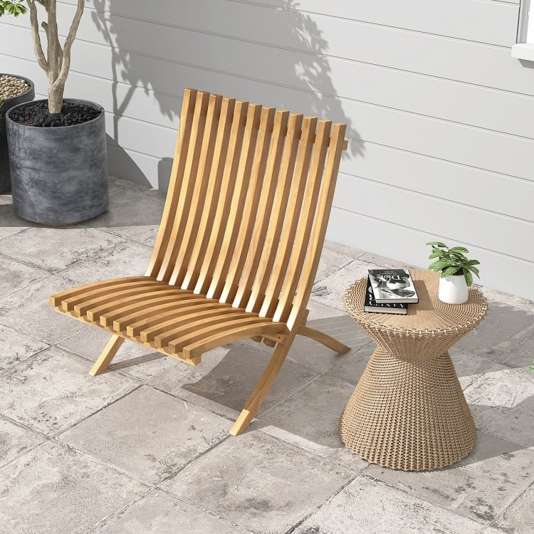 Folding teak wood outdoor lounge chair with slatted seat, perfect for patio relaxation and fire pit nights.