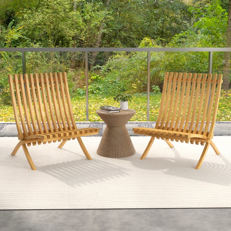 Two folding teak wood outdoor lounge chairs with slatted seats and backrests, perfect for patio relaxation.