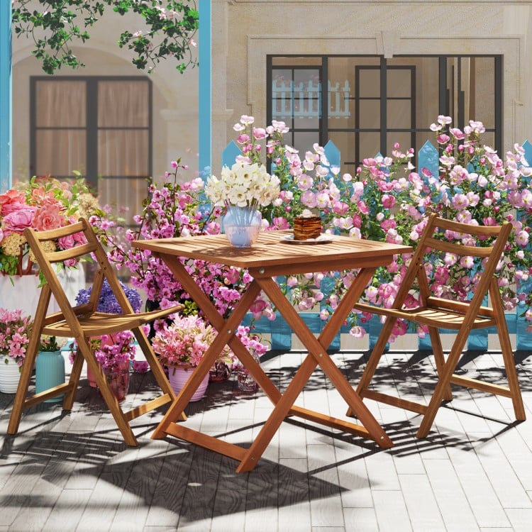 Teak-finished 29.5-inch patio dining table with umbrella hole, ideal for backyard or balcony relaxation.