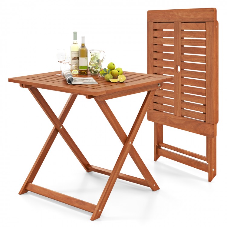 Folding patio dining table with teak finish, umbrella hole, and X-shaped structure for stability, perfect for outdoor.