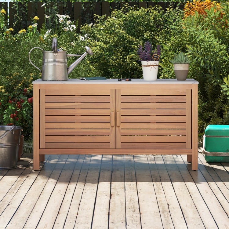 Acacia wood patio storage cabinet with faux marble top, featuring two doors and ample shelving for outdoor organization.