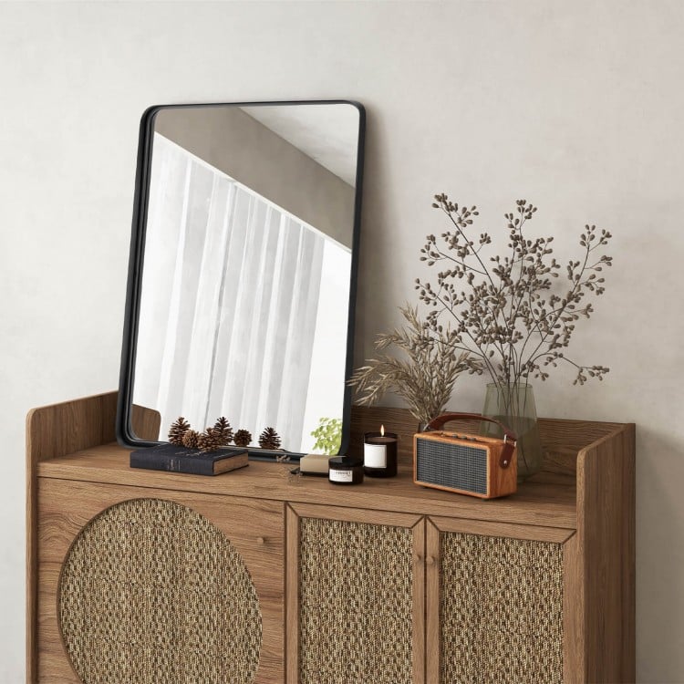 Rectangular wall mount bathroom mirror with solid steel frame, displayed on a wooden cabinet with decorative items.