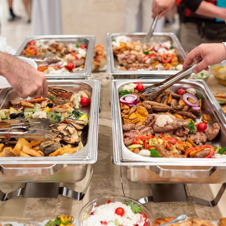 Stainless steel chafing dishes with food, featuring 9 QT capacity, ideal for buffets and gatherings.