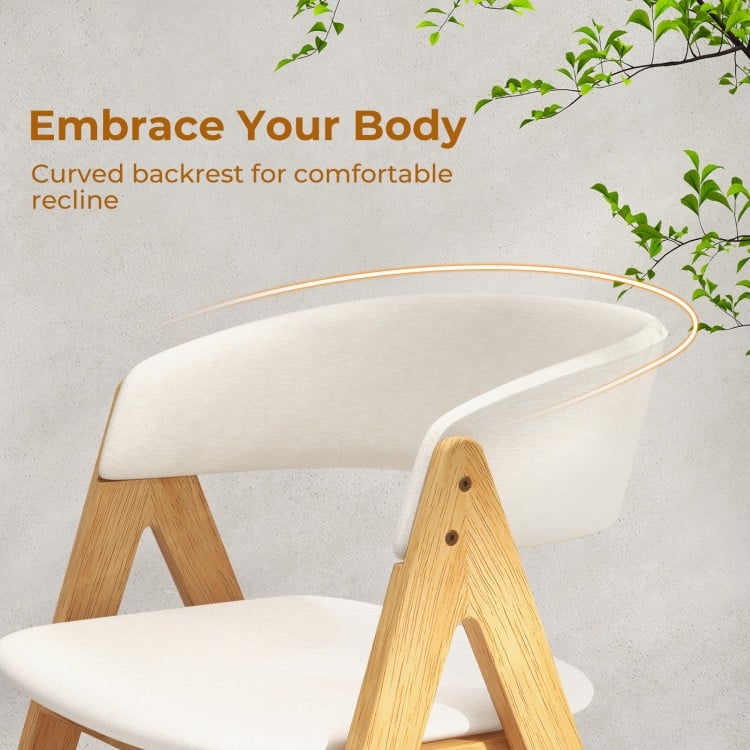 Curved backrest of a beige accent armchair with natural wood frame, designed for comfortable dining and relaxation.