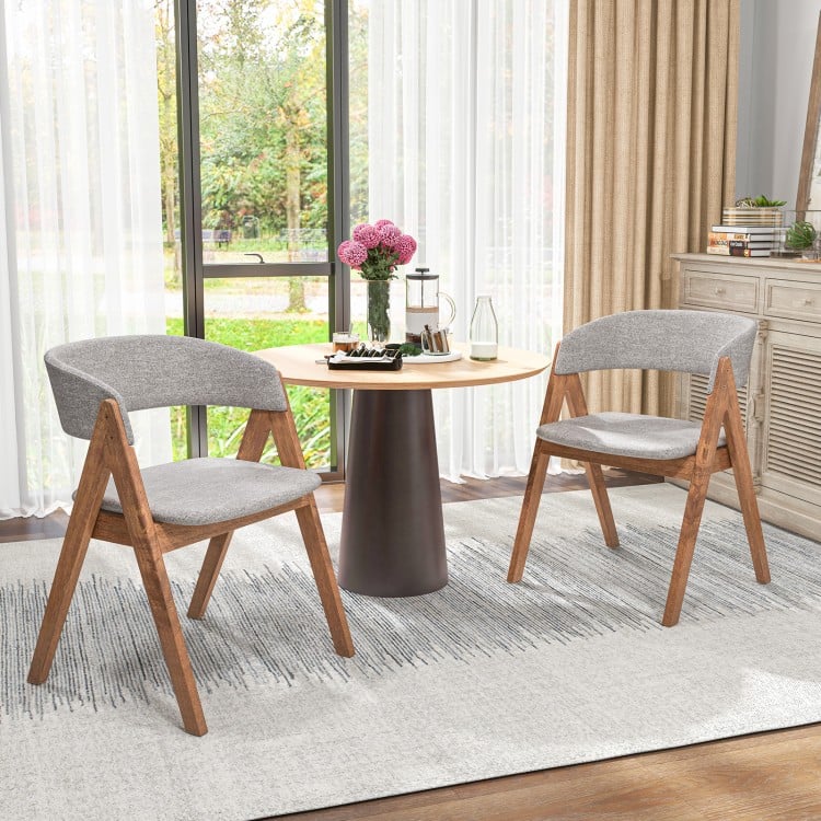 Set of 2 grey accent armchairs with walnut wood frame, perfect for dining rooms or kitchens, featuring curved backrests.