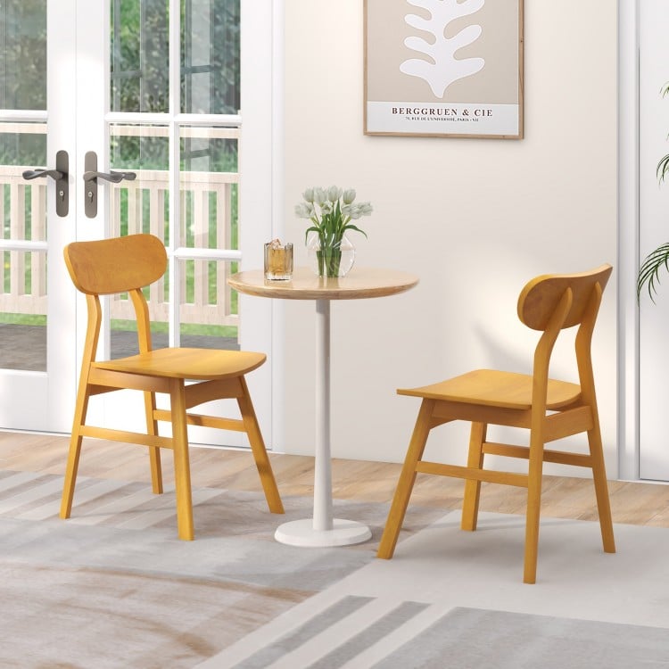 Set of 2 modern dining chairs with curved backrest in natural rubber wood, ideal for kitchen or dining room use.
