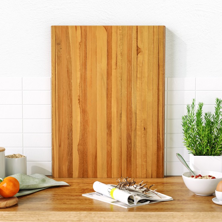 Extra large 24" teak wood cutting board with handles, featuring a reversible design for versatile kitchen use.