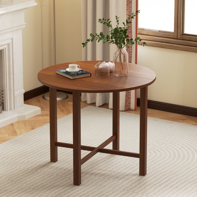 Round walnut drop leaf dining table with a flexible design, perfect for small spaces and accommodating 2-4 people.