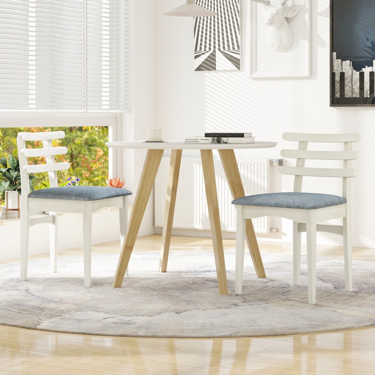 White fabric kitchen side chairs with rubber wood frame and padded seat, ideal for dining or study spaces.