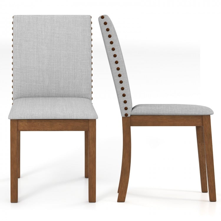 Upholstered dining chair set with padded seat, walnut frame, and decorative nailhead trim for elegant living room decor.