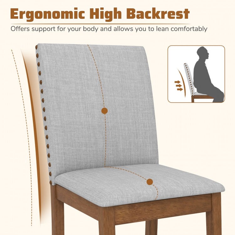 Ergonomic high backrest of upholstered dining chair with nailhead trim, designed for comfort and stability in living.