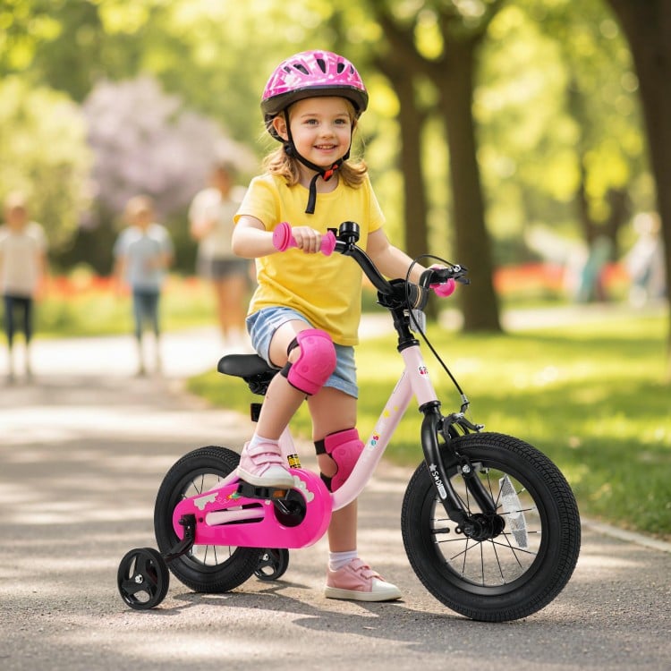 Pink 12-inch kids bike with training wheels, ergonomic seat, and dual brake system for safe riding outdoors.