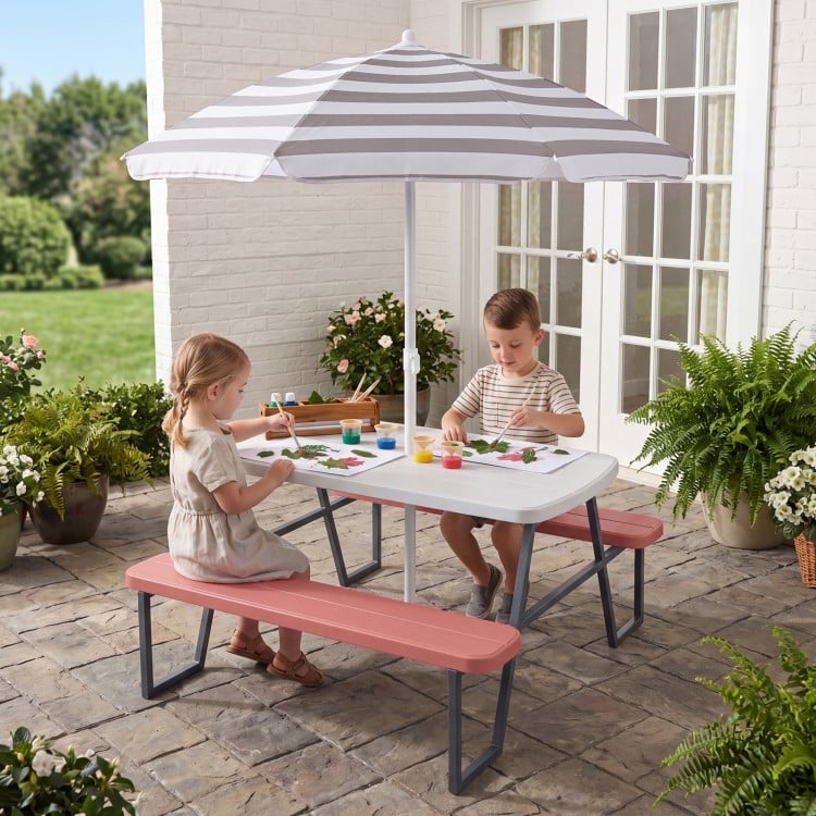 Kids picnic table with pink benches and a foldable umbrella, perfect for crafts and outdoor play. Seats up to 4.
