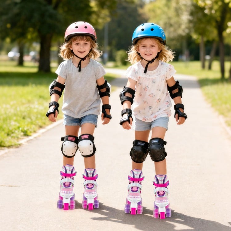 Two girls wearing adjustable kids roller skates with light-up wheels, protective gear, enjoying a sunny day outdoors.