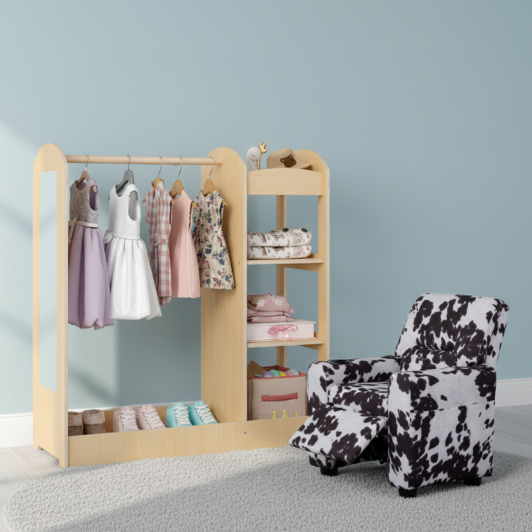 Kids dress-up storage wardrobe with mirror, featuring colorful costumes, alongside a cozy black & white recliner.