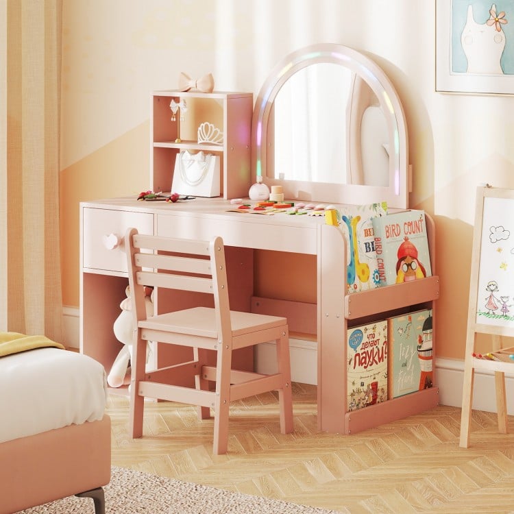 Kids vanity table set in pink with lighted mirror, open shelf, and ergonomic chair for safe and fun playroom use.