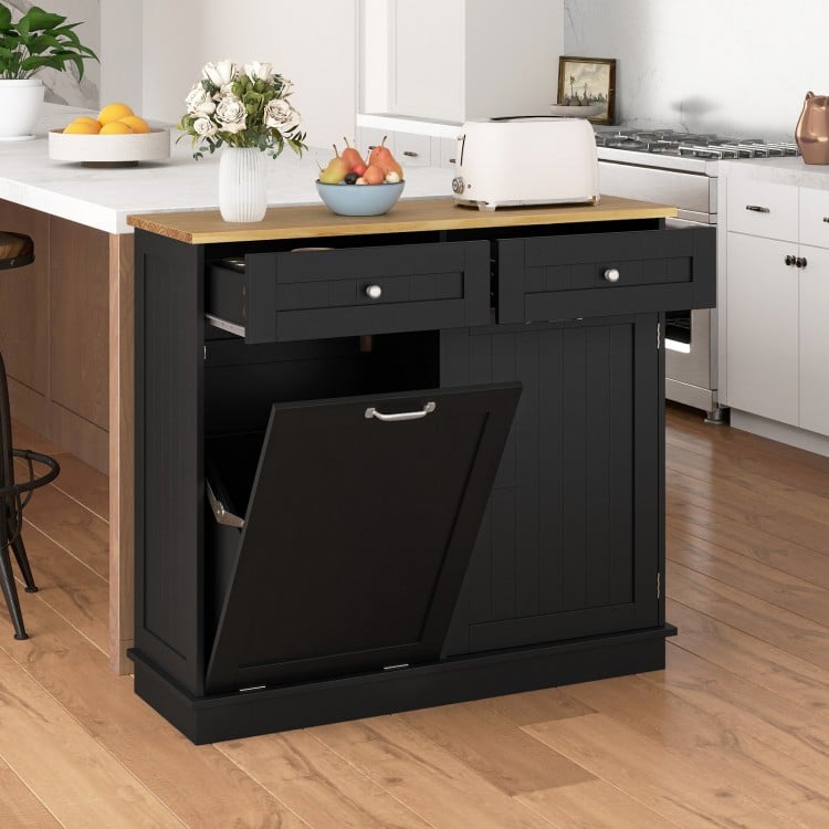 Kitchen tilt-out trash cabinet in black with two drawers, adjustable shelf, and ample countertop space for food.