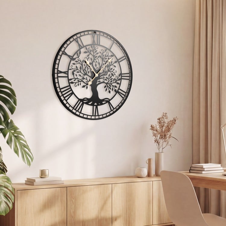 Large 27-inch black metal wall clock featuring a tree of life design, ideal for stylish home decor.