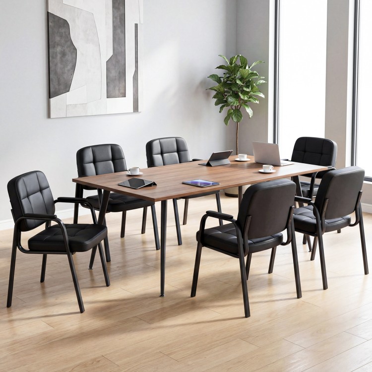 Set of four leather office reception chairs with cushioned seats and ergonomic backrests, ideal for meeting rooms.