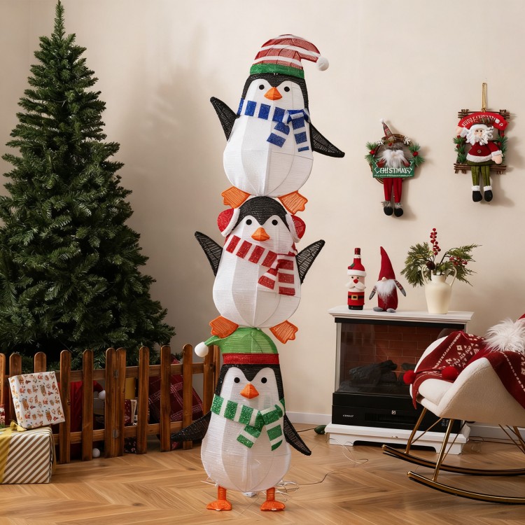 Three stacked lighted penguins wearing hats and scarves, featuring 156 warm white lights for festive decoration.