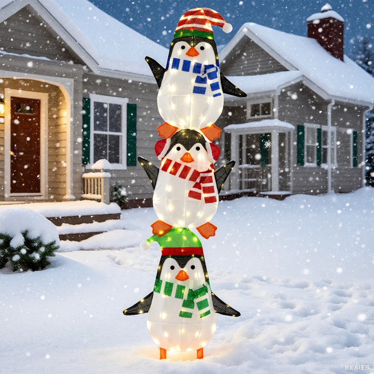 Stacked lighted penguins decoration with warm white lights and festive hats, perfect for Christmas outdoor displays.