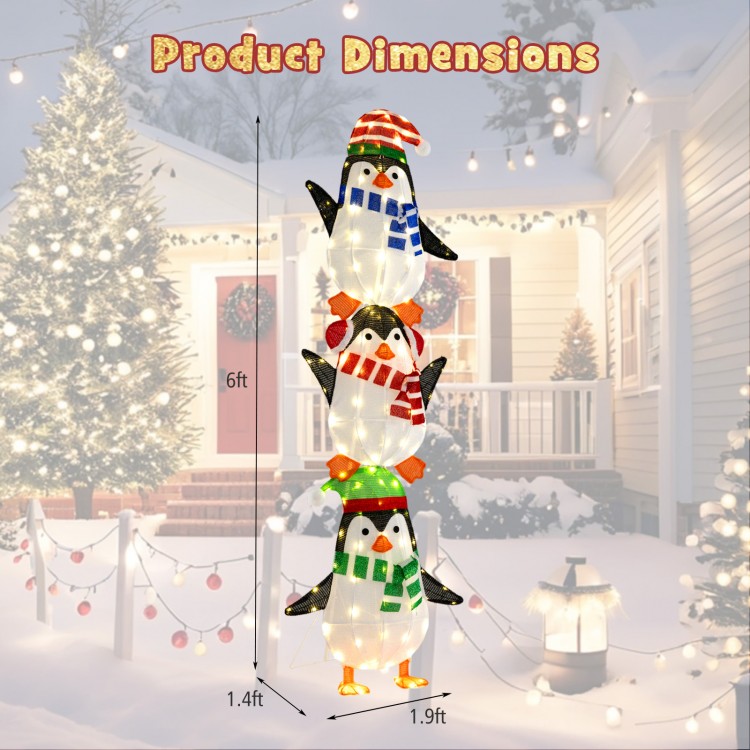Three lighted penguins decoration with warm white lights, wearing festive hats, perfect for Christmas outdoor displays.