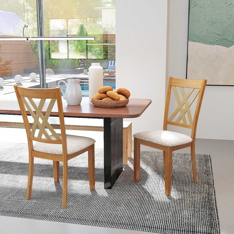 Wooden dining chairs with linen upholstery and X-shaped design, perfect for comfort in a natural dining room setting.
