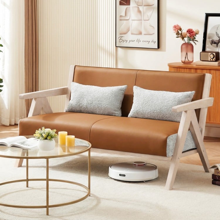 Brown loveseat sofa with gray throw pillows and ergonomic padded backrest, perfect for cozy living rooms and small.