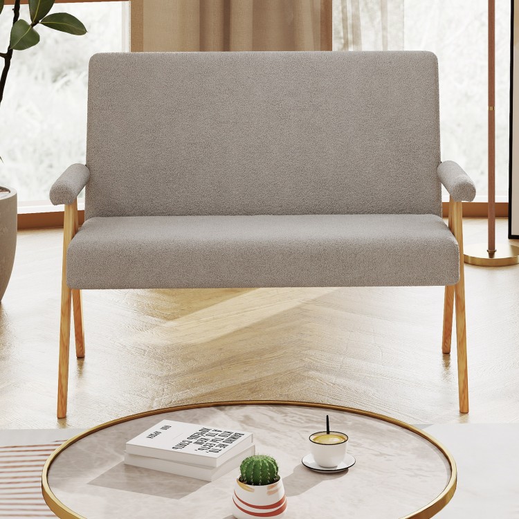 Gray loveseat sofa with armrests, wooden legs, and slanted backrest, perfect for small spaces in living rooms or.